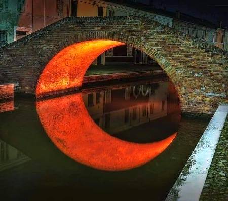 The artificial moon under a bridge