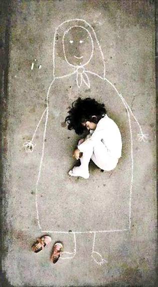 A young Iraqi orphanage girl-missing her mother so she drew her and fell asleep inside her.