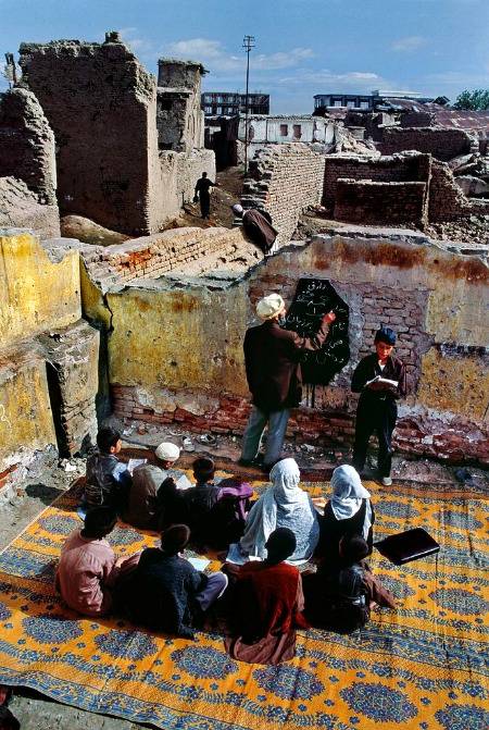 Student attend class in partially destroyed building in central kabul Afghanistan