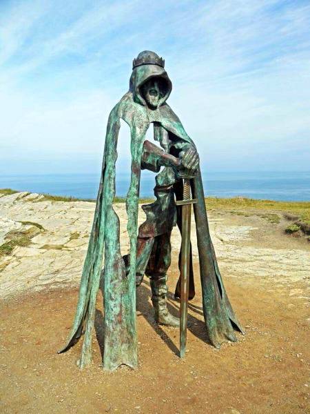 A statue of King Arthur on top of the tintagel cliffs in England