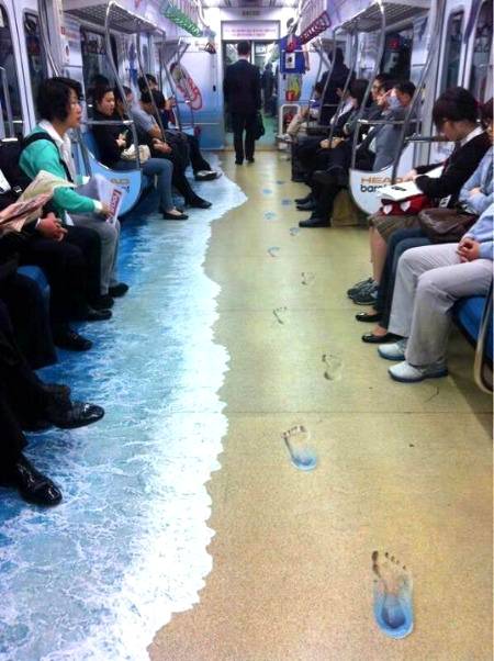 Korean subway car turned into a beach. Toes in the sand or the sea,your choice.